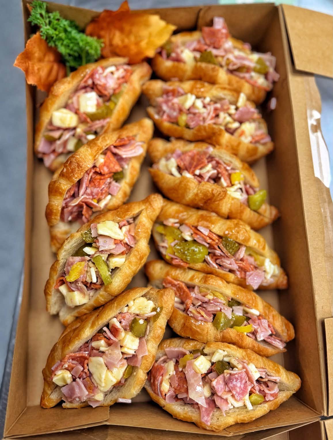 Mini croissant sandwiches with Italian meats, cheese, and pickles