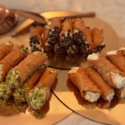 Assorted mini cannoli with pistachio, chocolate chip, and classic fillings